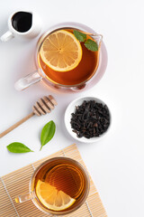 Design concept top view of honey black tea with lemon and mint.
