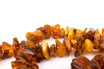 Baltic necklace made of Natural polished transparent honey luxury amber beads with inclusions on white. close up selective soft focus. Space for text