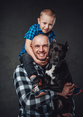 Joyful family of father with his son and dog