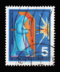 Stamp printed in Germany showing a welder with a protective suit, volunteer service technical aid agency, circa 1970