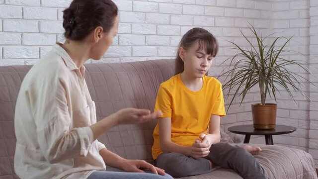 Angry mother with child. A stressed teen do not let her mother to talk and scream in the room.