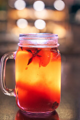 Close up of red drink non-alcoholic mulled wine with a straw on the background of the cafe interior, order for one
