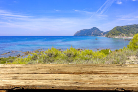Wooden desk of free space and summer beackground of sea 