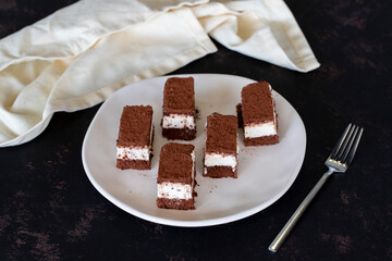 Small tiramisu cake on dark background