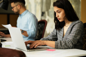 Happy businesswoman working on laptop. Portrait of beautiful businesswoman in the office..