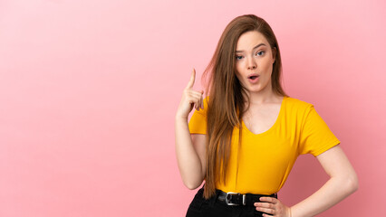 Teenager girl over isolated pink background intending to realizes the solution while lifting a finger up