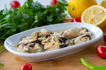 Marinated mussels on wooden background. Seafood dishes. local name marineli midye