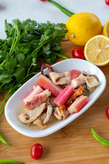 Seafood salad on wooden background. Seafood dishes. local name balık salatası