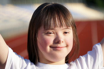 Little girl with Down Syndrome on the stadium - 441593573