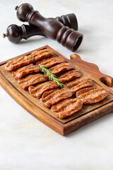 Spicy raw meatballs on wooden background. Turkish meatballs