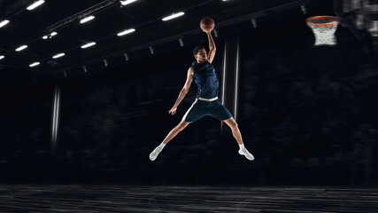Fototapeta na wymiar One young sportsman basketball player training in gym, idoors isolated on dark background. Concept of sport, game, competition. Slam dunk. Collage