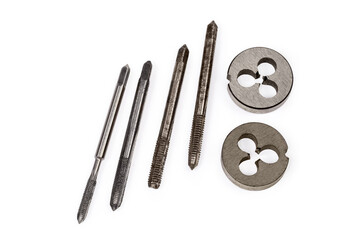 Different old thread cutting plug taps and dies, close-up