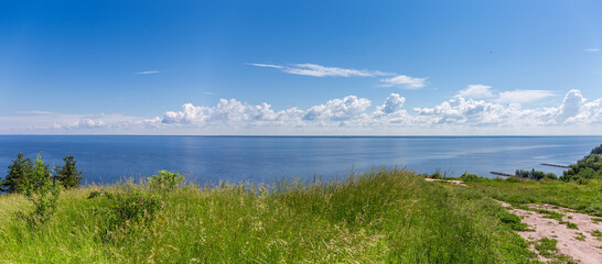 Panoramic view of big reservoir from steep shore in summer