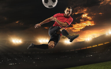 Fototapeta na wymiar Male football or soccer player at stadium - motion, action, activity concept