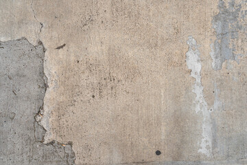 Rustic cement wall with repairs and stains. Texture wallpaper background.