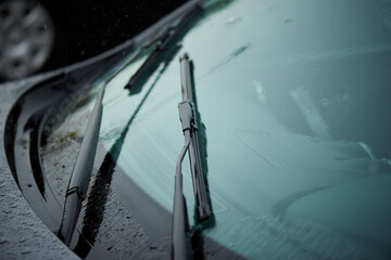 Car windshield wiper in the rain. - obrazy, fototapety, plakaty