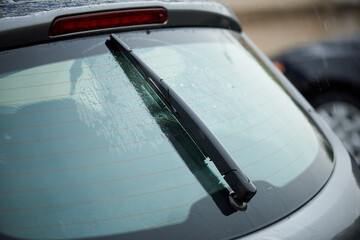 Working windshield wiper of a car in the rain.