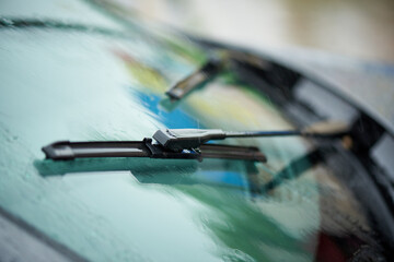 Working windshield wiper of a car from raindrops.