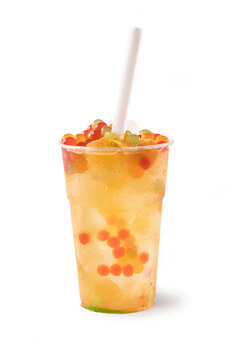 Bubble Tea, Isolated on White Background &ndash; Colorful, Fresh Orange Boba Drink with Fruit Fizzy Jellies and Ice Cubes, Wet with Droplets &ndash; Close Up Macro on Transparent Plastic Cup, with Straw