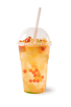 Bubble Tea, Isolated on White Background – Colorful, Fresh Orange Boba Drink with Fruit Fizzy Jellies and Ice Cubes, Wet with Droplets – Close Up Macro on Transparent Plastic Cup with Straw and Lid 