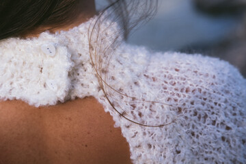 Details of woolen white dress, neck closure, open back