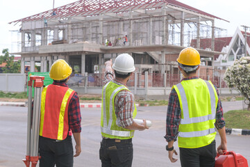 Construction engineers supervising progress of construction project
