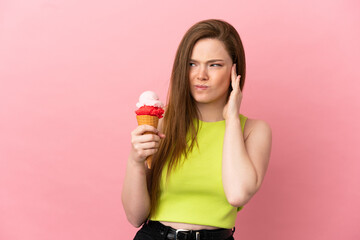 Teenager girl with a cornet ice cream over isolated pink background frustrated and covering ears