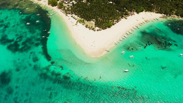 Tropical island with beautiful beach, palm trees and turquoise water view from above. Daco island, Philippines. Summer and travel vacation concept