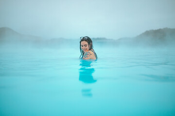Woman in water between stones