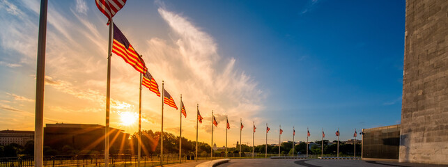 Sunrise over ring of American Flags around the Washington Monument in United States capitol with national mall and Smithsonian Museums in background.