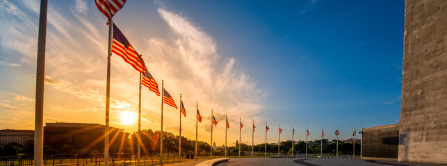 Sunrise over ring of American Flags around the Washington Monument in United States capitol with...