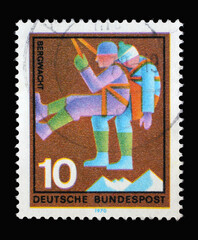 Stamp printed in Germany showing a rescuer with injuries: volunteer mountain rescue service, circa 1970