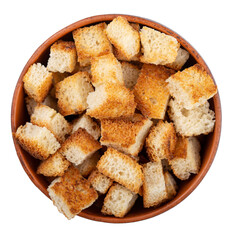 Bread rusks. Fried pieces of bread in a clay bowl isolated on white background. Caesar salad ingredients. Delicious snacks. Top view.