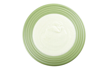 Cauliflower cream soup in a green plate isolated white background.