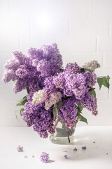 A bouquet of lilac on a light background. Shabby chic style. Soft focus.