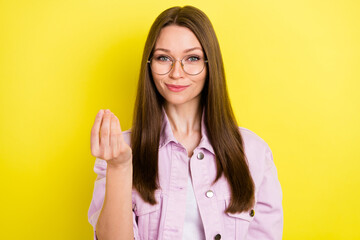 Portrait of attractive brainy cheerful girl lecturer explaining subject isolated over bright yellow...