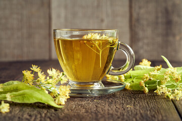 A cup of herbal tea with linden flowers. Herbal medicine.