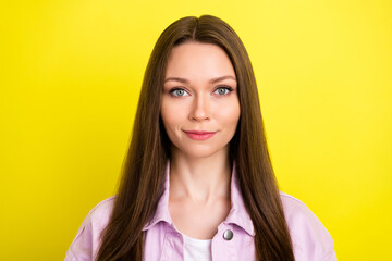 Portrait of attractive content brown-haired girl wearing casual shirt isolated over bright yellow color background