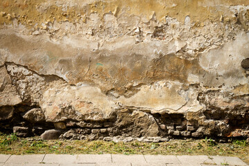 Old yellow plaster and brick wall