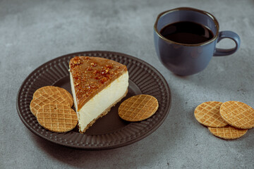 Slice of Crunchy Caramel's CheeseCake with cookies and coffee