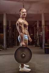 old fashion bodybuilder arm exercises in gym