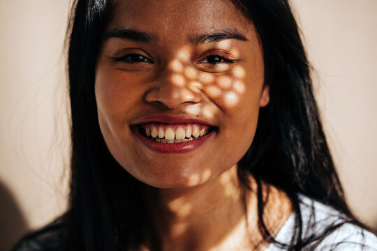 Dreamy young woman while looking at camera