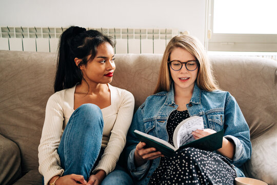 Pensive Women On Sofa Reading Book