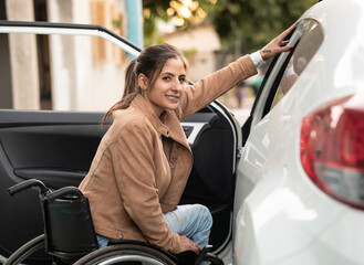 woman in wheelchair going inside of the car for a drive.