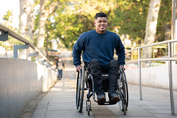 person in wheelchair finishing to climb access ramp.