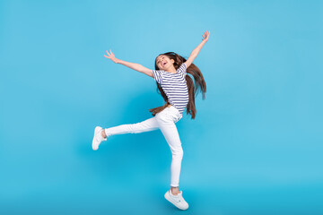 Fototapeta na wymiar Full length profile side photo of young cheerful girl happy positive smile have fun isolated over blue color background