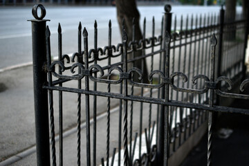 Steel fence made of twisted rods in the city