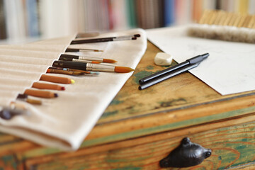 Graphic artist's work table with tools and brushes