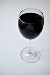 Large glass of red wine on a white background