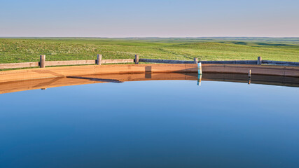 cattle water tank in a green prairie - Pawnee National Grassland in northern Colorado, late spring scanery